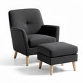 upholstered armchair and ottoman set in dark gray fabric with natural wood legs